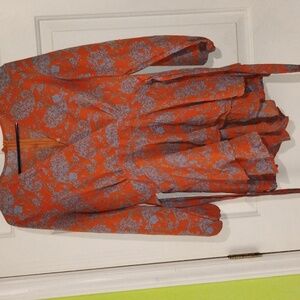 Long sleeve burnt orange and baby blue floral romper. Size large.